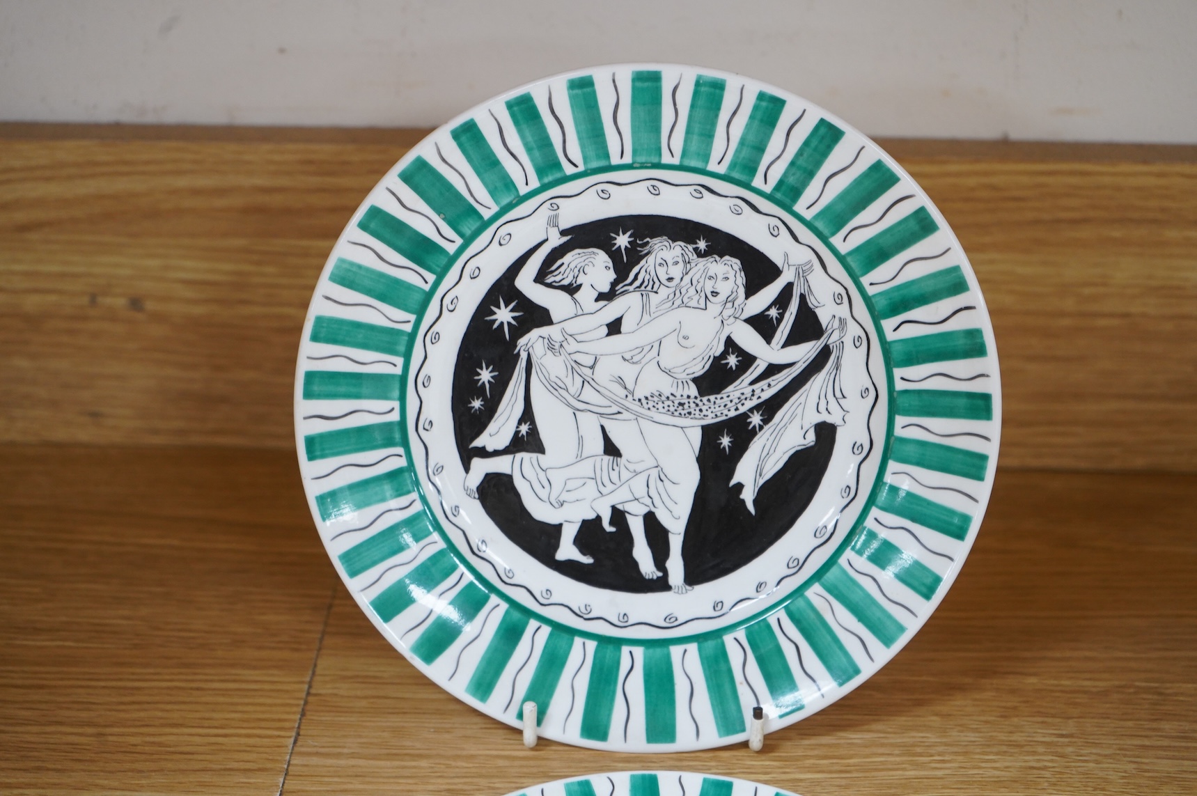Laura Knight for Foley China cupid plate and matching side plate, together with a Graham Sutherland for Foley China plate and matching side plate, largest 23cm in diameter
